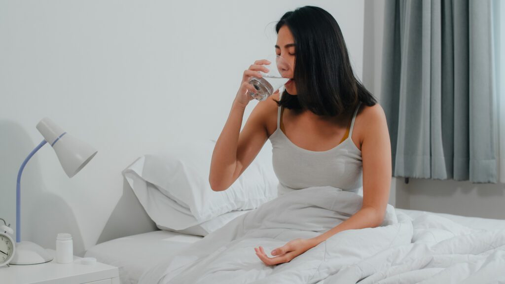person drinking water before bed